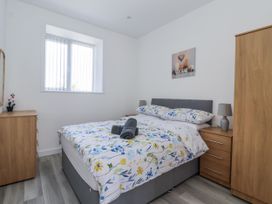A bedroom with a bed and bedside tables at Birch Cottage in Scarborough