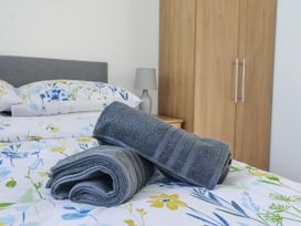 A bedroom with towels on a bed at Birch Cottage in Scarborough