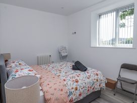 A bedroom with a bed and chair at Birch Cottage in Scarborough