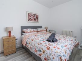 A bedroom with a bed and bedside table at Birch Cottage in Scarborough