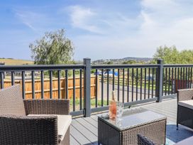 A deck with chairs and a table at Birch Cottage in Scarborough