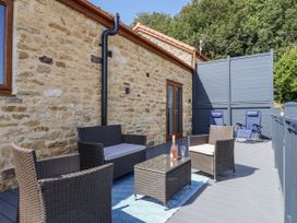An outdoor seating area with chairs and a table at Birch Cottage in Scarborough