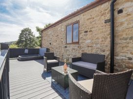 An outdoor area with seating and a hot tub at Birch Cottage in Scarborough