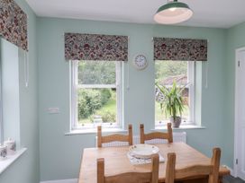A dining room with a table and chairs at Whinstone Cottage Esk Valley near Grosmont
