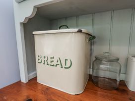 A bread bin and glass jar on a countertop at Whinstone Cottage Esk Valley near Grosmont