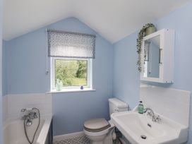 A bathroom with a bathtub, toilet, and sink at Whinstone Cottage Esk Valley near Grosmont