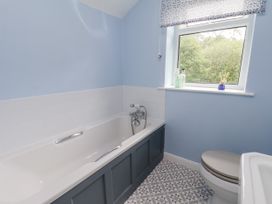 A bathroom with a bathtub and a toilet at Whinstone Cottage in Esk Valley near Grosmont