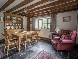 A dining room with a table and chairs at Cove Cottage in Llangrannog