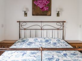 A bedroom with a bed and bedside tables at Y Bwthyn in Llangrannog