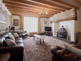 A living room with a fireplace and sofa at Coach House in Llangrannog