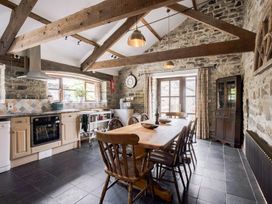A kitchen with dining table and chairs at Coach House in Llangrannog