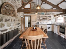 A kitchen with a table and chairs at Coach House in Llangrannog