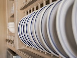A shelf with plates arranged at Coach House Llangrannog