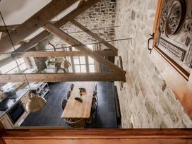 A kitchen with a dining table and chairs at Coach House Llangrannog