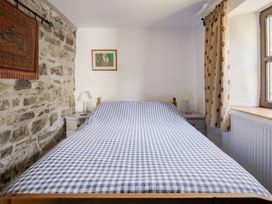 A bedroom with a bed and lamp at Coach House in Llangrannog
