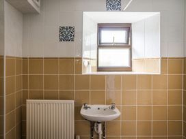 A bathroom with a sink and window at Coach House in Llangrannog