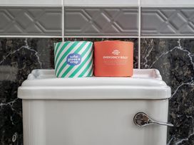 A toilet with toilet paper rolls at Coach House Llangrannog