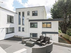 An outdoor area with seating and a table at Treliance in Truro