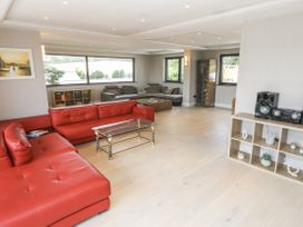 A living room with a red sofa and coffee table at Treliance in Truro