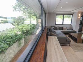 A living room with a window, couch, and coffee table at Treliance in Truro