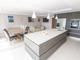 A kitchen with an island and dining area at Treliance in Truro