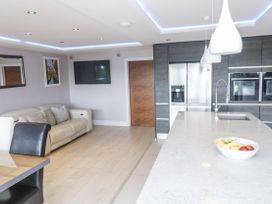 A kitchen with a couch and dining table at Treliance in Truro