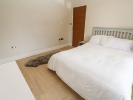 A bedroom with a bed and door at Treliance in Truro