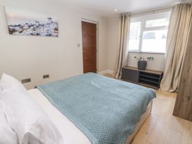 A bedroom with a bed and window at Treliance in Truro