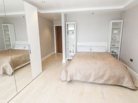 A bedroom with a bed and shelves at Treliance in Truro