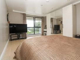 A bedroom with a bed and television at Treliance in Truro
