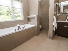 A bathroom with a bathtub, toilet, and sink at Treliance in Truro