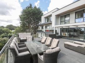 An outdoor seating area with a table and chairs at Treliance in Truro