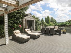 An outdoor patio with loungers and a dining area at Treliance in Truro