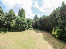 A garden area with trees and grass at Treliance in Truro