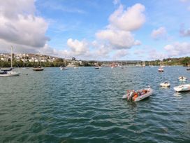 A view of boats on water with houses in the background at Treliance in Truro