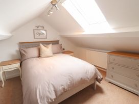 A bedroom with a bed and nightstands at 3 Rosemary Lane Conwy
