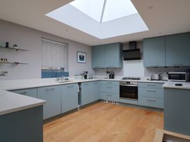 A kitchen with cabinets, oven, and sink at The Well House in Lyme Regis