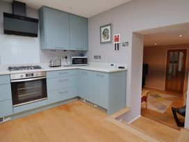 A kitchen with appliances and cabinets at The Well House in Lyme Regis