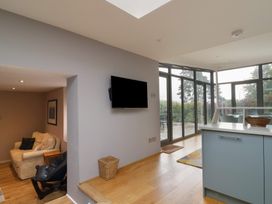 A living room with a sofa and television at The Well House in Lyme Regis