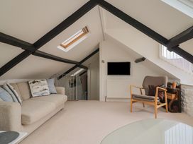 A snug with a sofa and television at The Well House in Lyme Regis