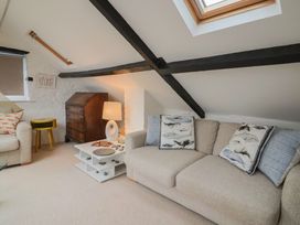 A living room with a sofa and coffee table at The Well House in Lyme Regis