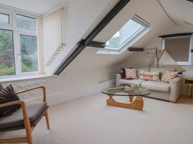 A living room with a window and a sofa at The Well House in Lyme Regis
