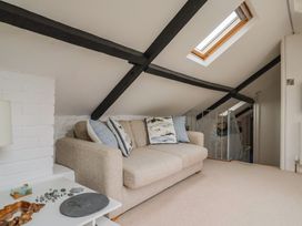 A snug with a sofa and coffee table at The Well House in Lyme Regis