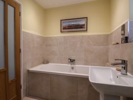 A bathroom with a bathtub and sink at The Well House in Lyme Regis