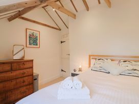 A bedroom with a bed and dresser at The Well House in Lyme Regis