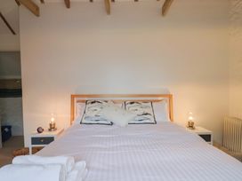 A bedroom with a bed and bedside tables at The Well House Lyme Regis