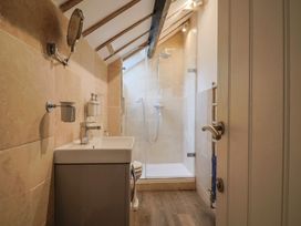 A bathroom with a shower and sink at The Well House in Lyme Regis