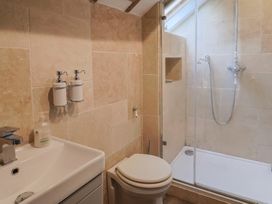 A bathroom with a sink and shower at The Well House Lyme Regis