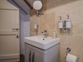 A bathroom with a sink and mirror at The Well House in Lyme Regis