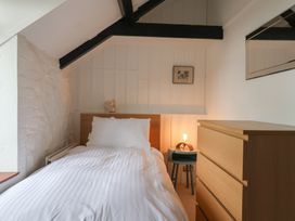 A bedroom with a bed and dresser at The Well House in Lyme Regis